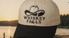 Whiskey Falls cap on a dock at sunset